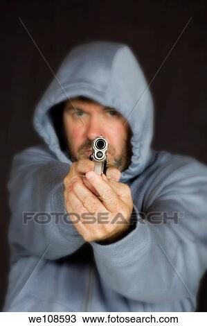 Man hold gun in a threatening pose View Large Photo Image Stock Image - Man hold gun in a threatening pose. Fotosearch