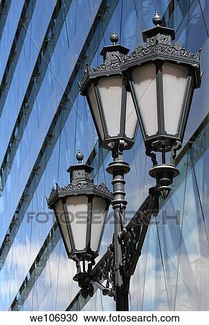 Old street lamp in front of modern buildings View Large Photo Image Stock Image - Old street lamp in front of modern buildings. Fotosearch
