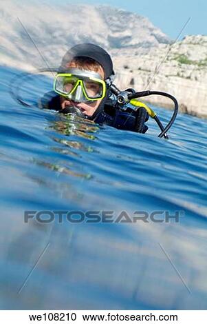 One scuba diver resurfaces near Ile de Riou, Marseille, France View Large Photo Image Stock Image - One scuba diver resurfaces near Ile de Riou, Marseille, France. Fotosearch
