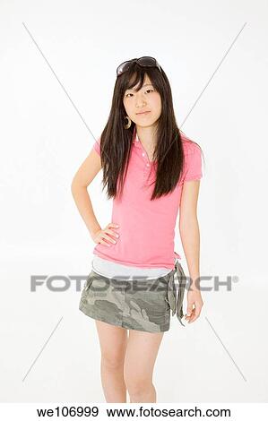 Stock Photo - Portrait of a beautiful Asian teenager posing on a white background. Fotosearch