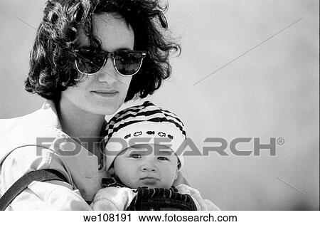 Stock Image - Portrait of a mother embracing her one year old baby boy, Marseille, France. Fotosearch