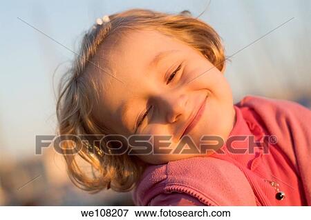 Portrait of a smiling little girl at sunset, France View Large Photo Image Stock Photo - Portrait of a smiling little girl at sunset, France. Fotosearch