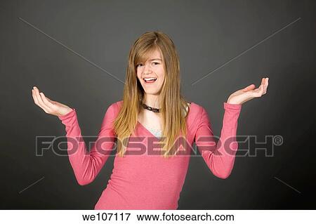 Preteen girl posing on gray background with some attitude View Large Photo Image Stock Photo - Preteen girl posing on gray background with some attitude. Fotosearch