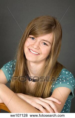 Preteen girl posing on gray background with some attitude View Large Photo Image Stock Photo - Preteen girl posing on gray background with some attitude. Fotosearch