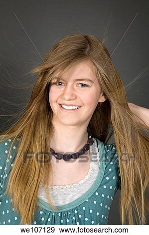 Preteen girl posing on gray background with some attitude View Large Photo Image Stock Photo - Preteen girl posing on gray background with some attitude. Fotosearch