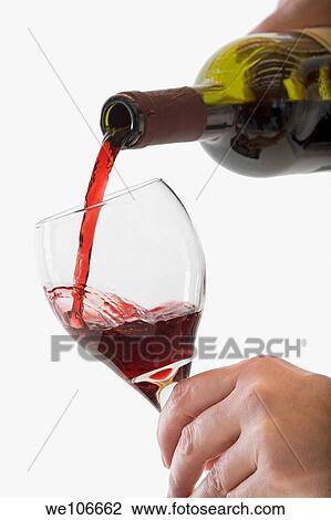 Stock Image - Red Wine pouring into glass. Fotosearch