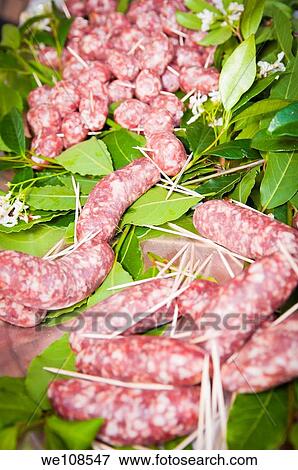 Stock Photo - Sausages with laurel leaves. Fotosearch