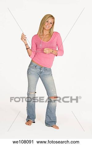 Stock Image - Teenage girl listening to music. Fotosearch