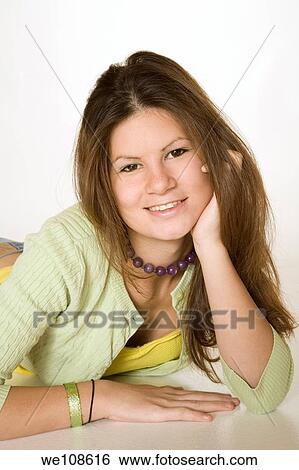 Teenage girl posing on a white background View Large Photo Image Stock Photograph - Teenage girl posing on a white background. Fotosearch