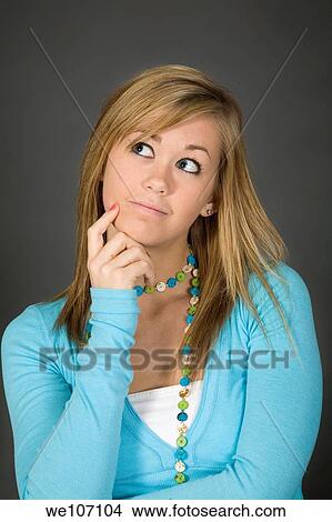 Teenage girl posing on gray background with some attitude View Large Photo Image Picture - Teenage girl posing on gray background with some attitude. Fotosearch