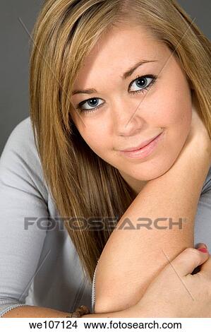 Teenage girl posing on gray background with some attitude View Large Photo Image Picture - Teenage girl posing on gray background with some attitude. Fotosearch