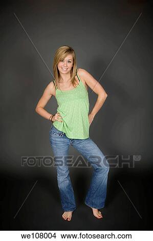Teenage girl posing on gray background with some attitude View Large Photo Image Picture - Teenage girl posing on gray background with some attitude. Fotosearch