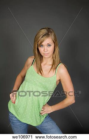 Teenage girl posing on gray background with some attitude View Large Photo Image Stock Image - Teenage girl posing on gray background with some attitude. Fotosearch
