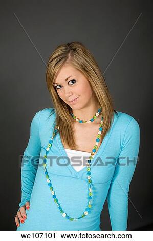 Teenage girl posing on gray background with some attitude View Large Photo Image Stock Image - Teenage girl posing on gray background with some attitude. Fotosearch