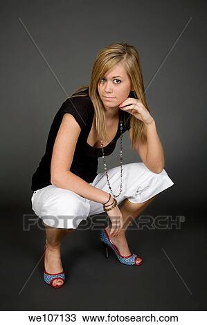 Teenage girl posing on gray background with some attitude View Large Photo Image Stock Image - Teenage girl posing on gray background with some attitude. Fotosearch
