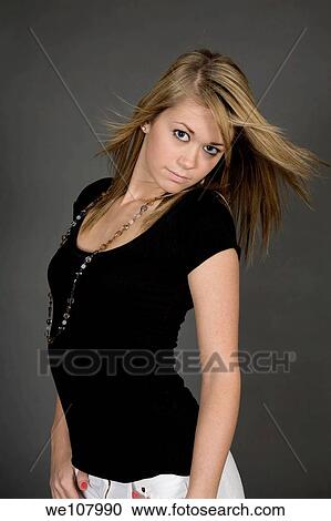 Teenage girl posing on gray background with some attitude View Large Photo Image Stock Image - Teenage girl posing on gray background with some attitude. Fotosearch