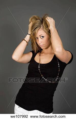 Teenage girl posing on gray background with some attitude View Large Photo Image Stock Image - Teenage girl posing on gray background with some attitude. Fotosearch