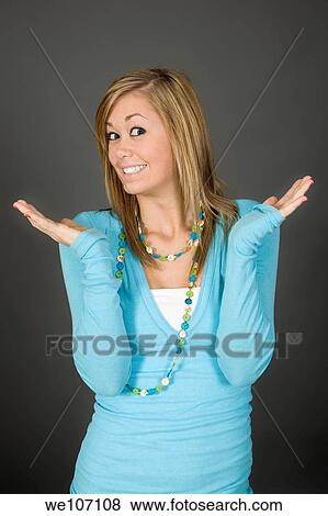 Stock Photo - Teenage girl posing on gray background with some attitude. Fotosearch
