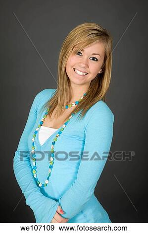 Teenage girl posing on gray background with some attitude View Large Photo Image Stock Photo - Teenage girl posing on gray background with some attitude. Fotosearch