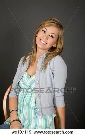 Teenage girl posing on gray background with some attitude View Large Photo Image Stock Photo - Teenage girl posing on gray background with some attitude. Fotosearch