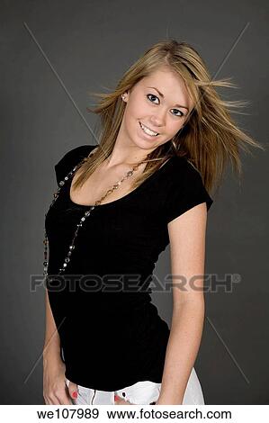 Stock Photo - Teenage girl posing on gray background with some attitude. Fotosearch