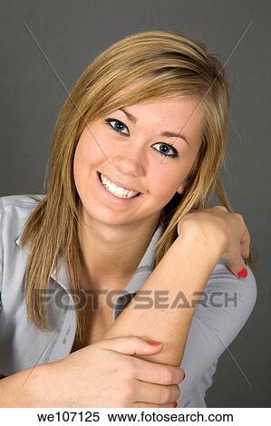 Teenage girl posing on gray background with some attitude View Large Photo Image Stock Photography - Teenage girl posing on gray background with some attitude. Fotosearch