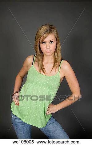 Teenage girl posing on gray background with some attitude View Large Photo Image Stock Photography - Teenage girl posing on gray background with some attitude. Fotosearch
