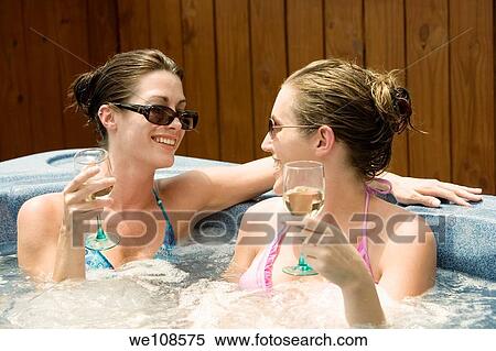 Two women in their mid 20s enjoying a relaxing moment in a hottub View Large Photo Image Stock Photography - Two women in their mid 20s enjoying a relaxing moment in a hottub. Fotosearch