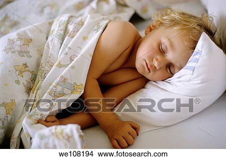 Two year old girl asleep in bed, France View Large Photo Image Picture - Two year old girl asleep in bed, France. Fotosearch