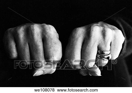 Woman clenching two hands into fists in a fit of aggression View Large Photo Image Stock Photo - Woman clenching two hands into fists in a fit of aggression. Fotosearch
