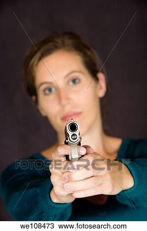 Woman defending herself with handgun View Large Photo Image Stock Image - Woman defending herself with handgun. Fotosearch