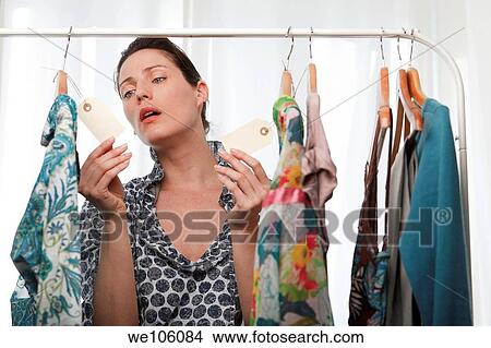 Woman in a clothes shop View Large Photo Image Picture - Woman in a clothes shop. Fotosearch