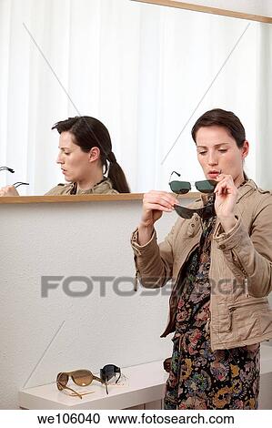 Woman in a clothes shop View Large Photo Image Stock Image - Woman in a clothes shop. Fotosearch