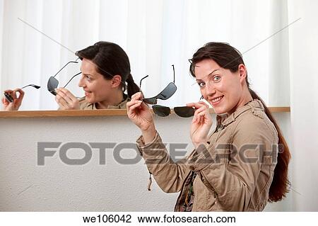 Woman in a clothes shop View Large Photo Image Stock Image - Woman in a clothes shop. Fotosearch