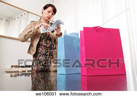 Woman in a clothes shop View Large Photo Image Stock Image - Woman in a clothes shop. Fotosearch