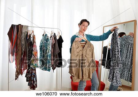 Woman in a clothes shop View Large Photo Image Stock Image - Woman in a clothes shop. Fotosearch