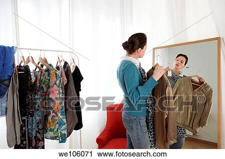 Woman in a clothes shop View Large Photo Image Stock Image - Woman in a clothes shop. Fotosearch