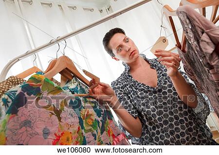 Woman in a clothes shop View Large Photo Image Stock Image - Woman in a clothes shop. Fotosearch