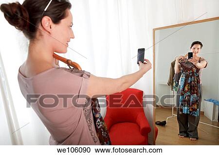 Woman in a clothes shop View Large Photo Image Stock Image - Woman in a clothes shop. Fotosearch