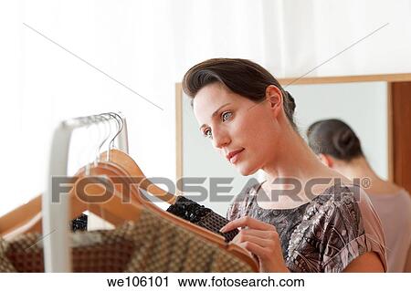 Woman in a clothes shop View Large Photo Image Stock Image - Woman in a clothes shop. Fotosearch