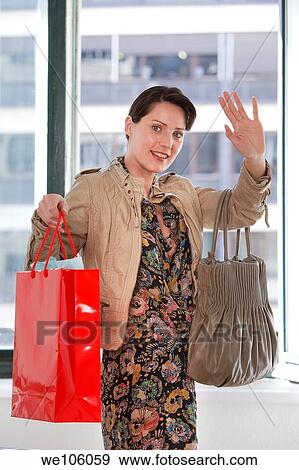 Stock Photo - Woman in a clothes shop. Fotosearch