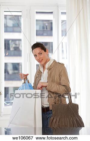 Woman in a clothes shop View Large Photo Image Stock Photo - Woman in a clothes shop. Fotosearch