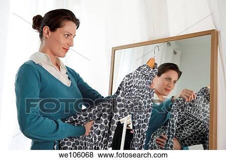 Stock Photo - Woman in a clothes shop. Fotosearch