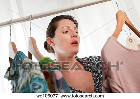 Woman in a clothes shop View Large Photo Image Stock Photo - Woman in a clothes shop. Fotosearch