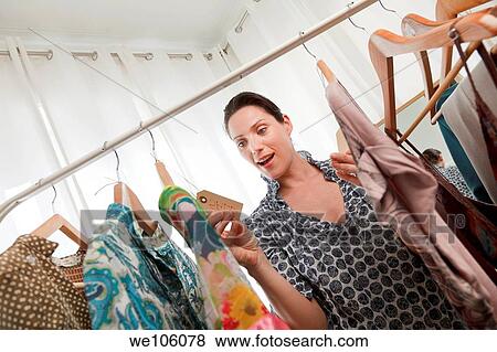 Woman in a clothes shop View Large Photo Image Stock Photo - Woman in a clothes shop. Fotosearch