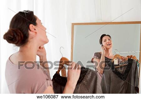 Stock Photo - Woman in a clothes shop. Fotosearch