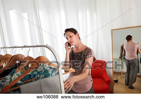 Woman in a clothes shop View Large Photo Image Stock Photo - Woman in a clothes shop. Fotosearch