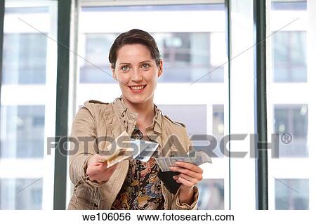 Stock Photograph - Woman in a clothes shop. Fotosearch