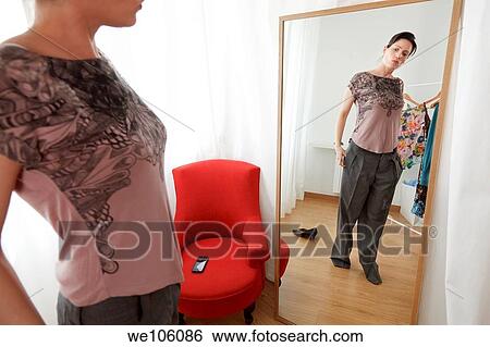 Woman in a clothes shop View Large Photo Image Stock Photograph - Woman in a clothes shop. Fotosearch