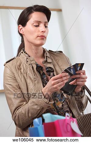 Stock Photography - Woman in a clothes shop. Fotosearch